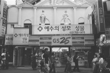 Myeong-dong-strange juxtaposition convenience store and church.jpg